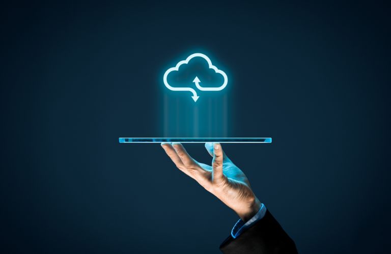 Person Holding a Tablet with Cloud-Based Graphic Above on Black Background