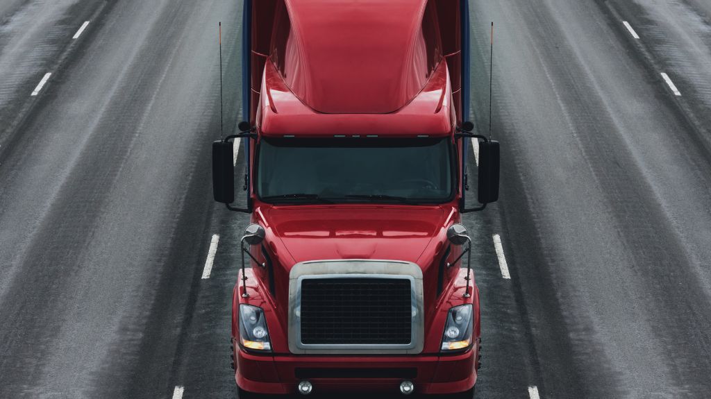 Red Semi Truck Driving on a Highway