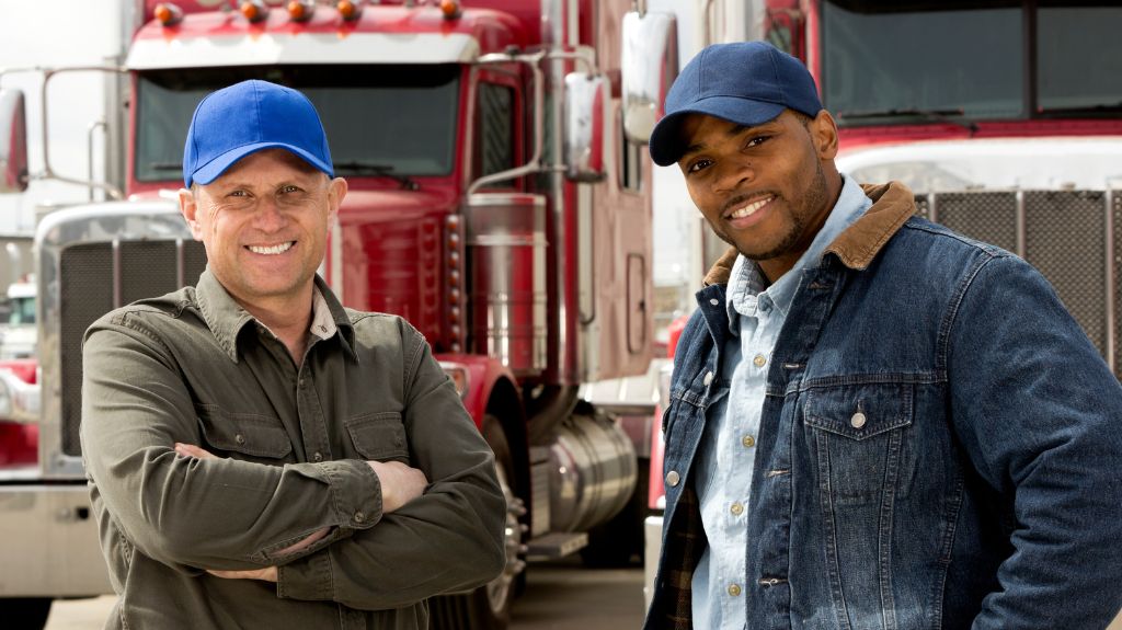 Two Truck Drivers in Front of Semi Trucks