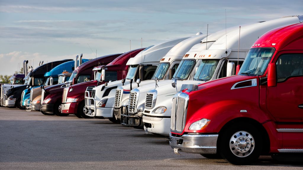 Line of Semi Trucks in a Parking Lot