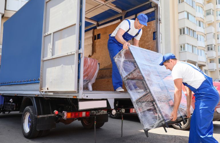 Two Men Loading Cargo in a Box Truck