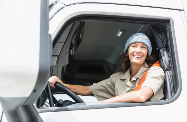 Woman Truck Driver in a White Semi Truck