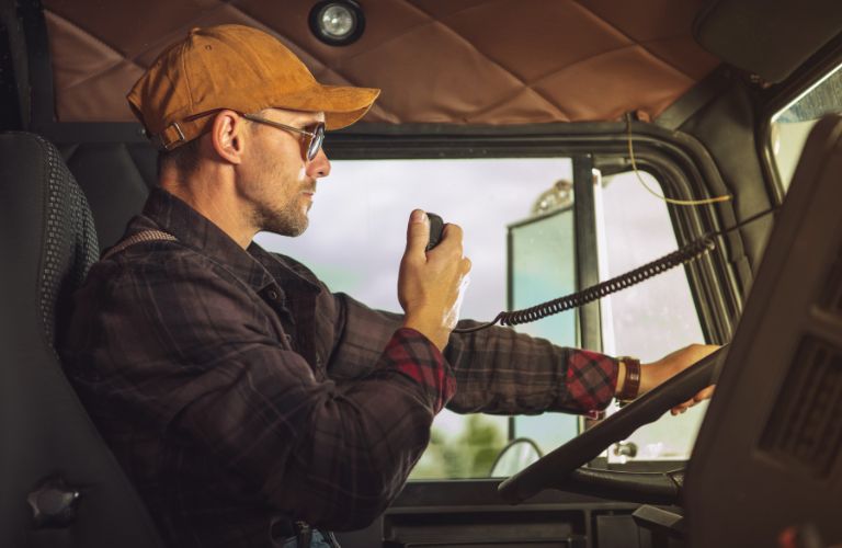 Trucker on the CB Radio in His Truck