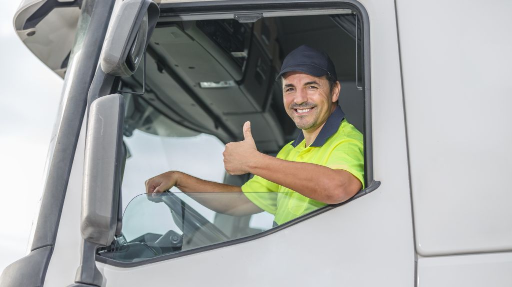 Truck Driver Giving Thumbs Up in a Truck