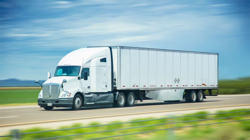White Semi Truck and Trailer on Country Highway