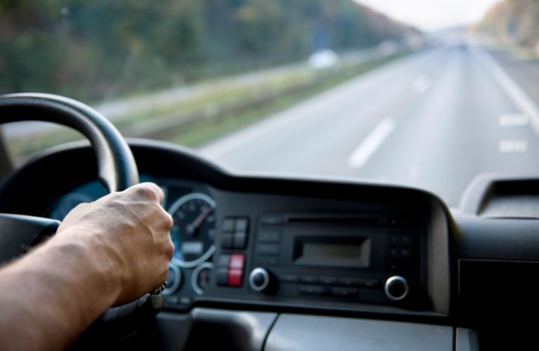 Man Behind the Wheel of Semi Truck on a Highway
