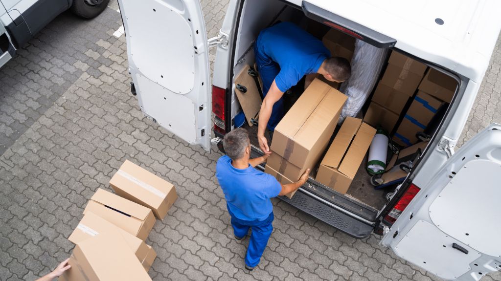 Men Unloading Boxes from the Back of a Truck
