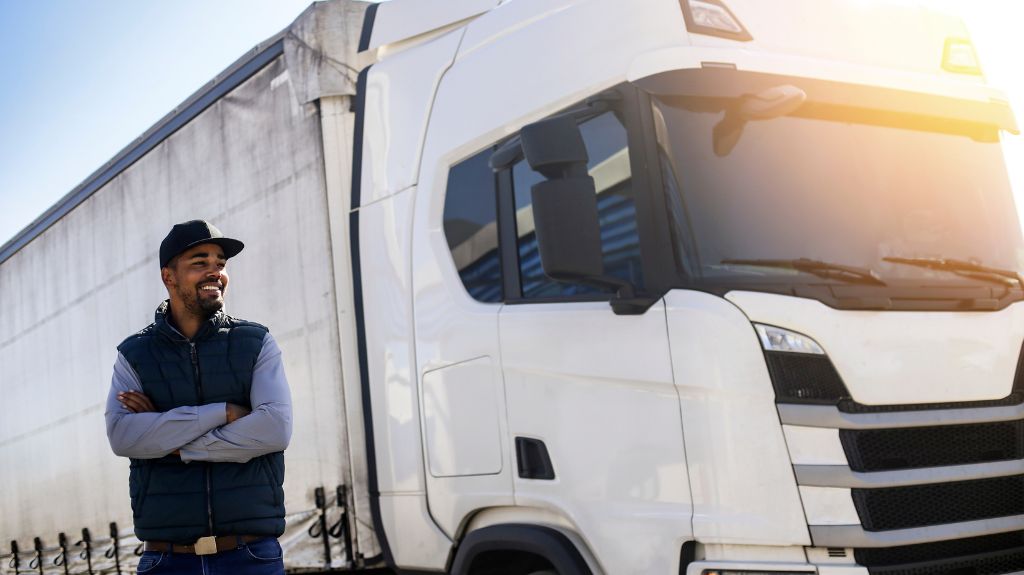 Man Standing Next to White Semi Truck