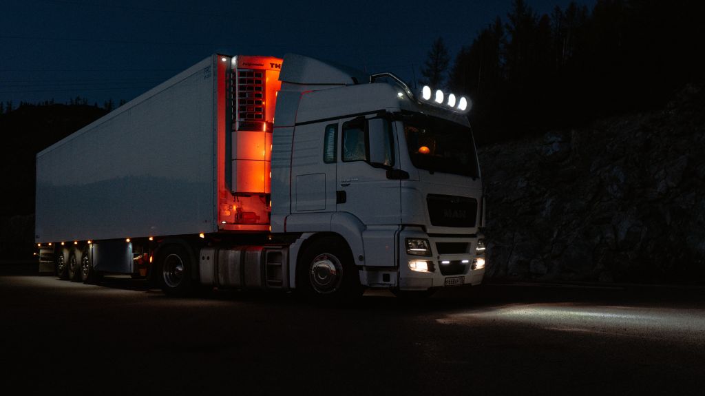 White Semi Truck on a Highway at Night