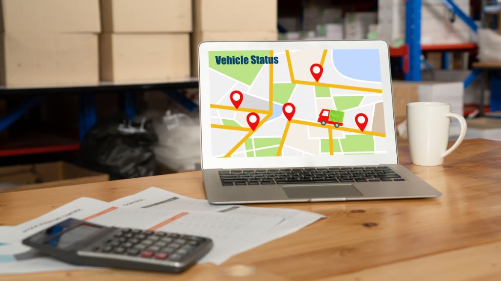 Laptop on a Table with Shipment Location Pins on a Map